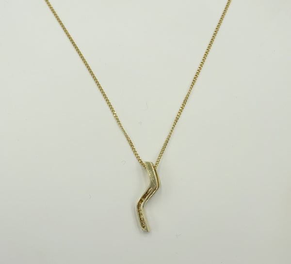 9ct gold CZ set Zig Zag style pendant on a chain. 2gr