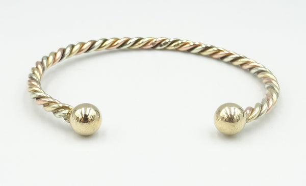 9ct gold 3 colour twisted child's torque bangle. 6.13gr