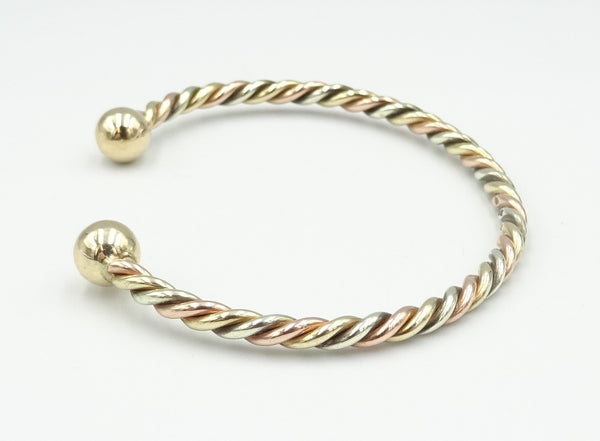 9ct gold 3 colour twisted child's torque bangle. 6.13gr